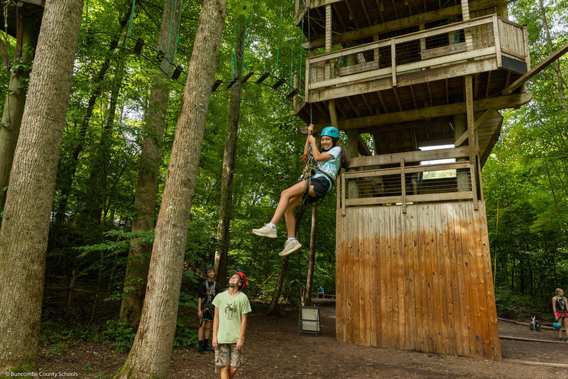 A girl comes down a self-belay system.