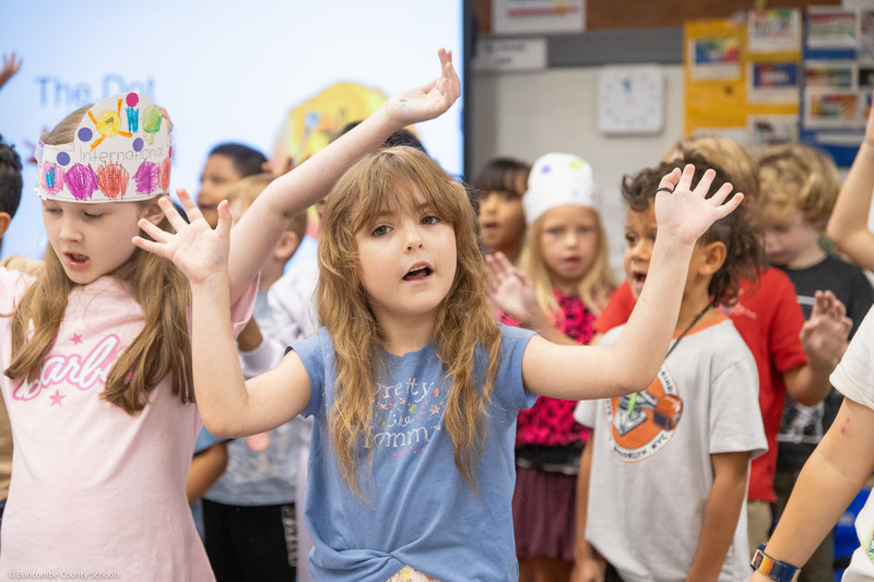Students move their hands while singing "The Dot Song."