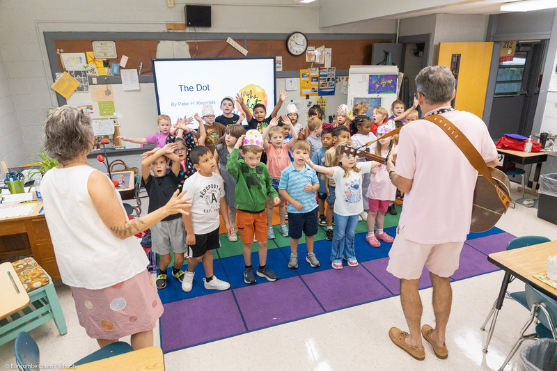 Students move their hands while singing "The Dot Song."