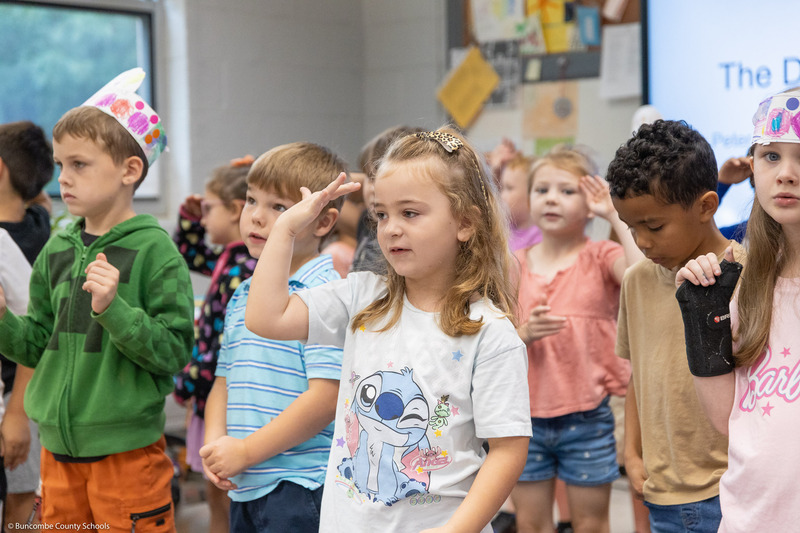 Students move their hands while singing "The Dot Song."