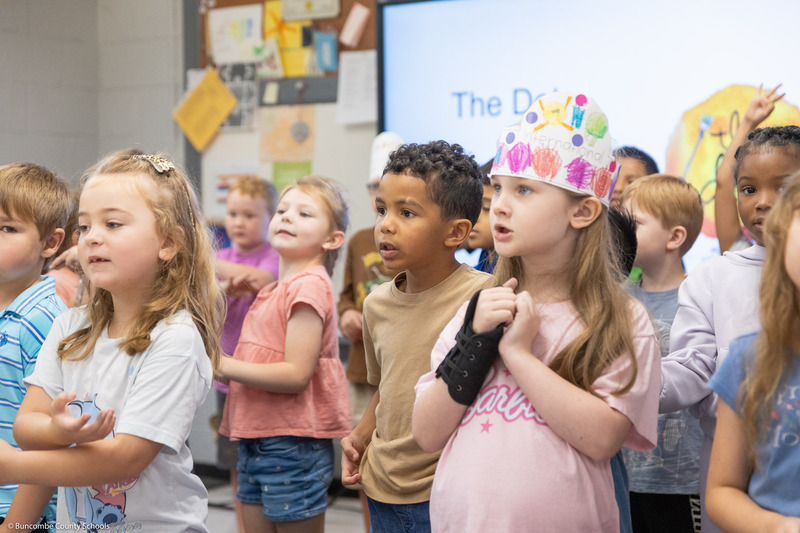Students move their hands while singing "The Dot Song."