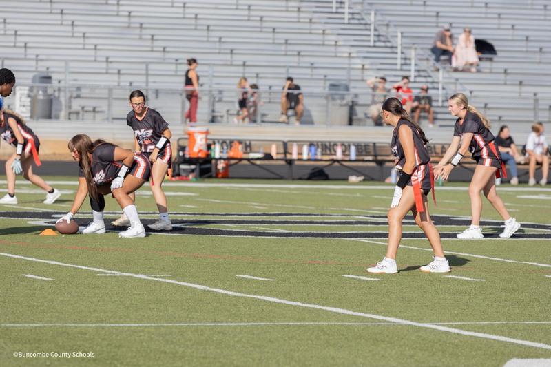 Lady hawks on football field