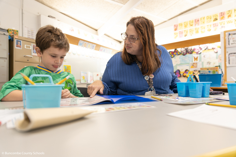 Ms. Buckner helping a student do a math problem.