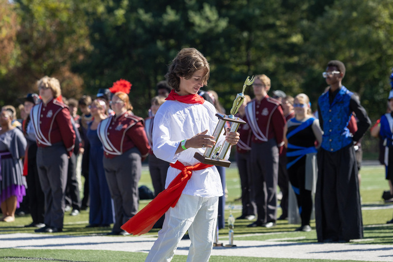 An Owen High student holds a trophy.