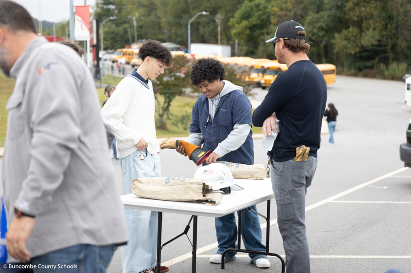 Group of student checking lineman equipment.
