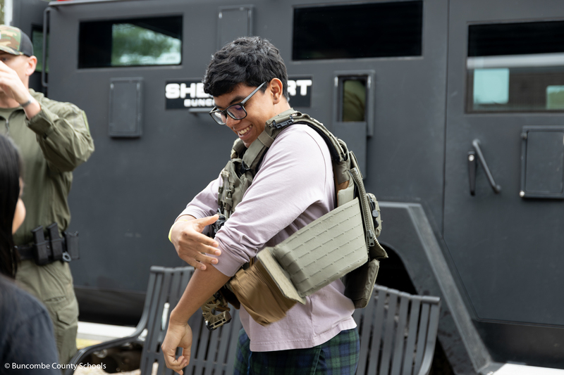 Student trying on a police vest.