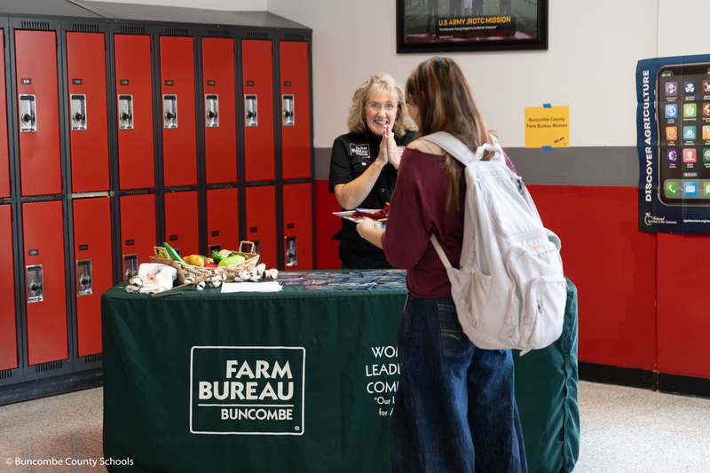 Student taking to a lady from Farm Bureau.