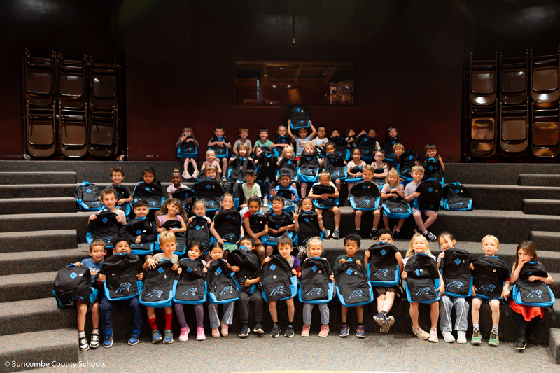 Group photo of students with their backpacks.