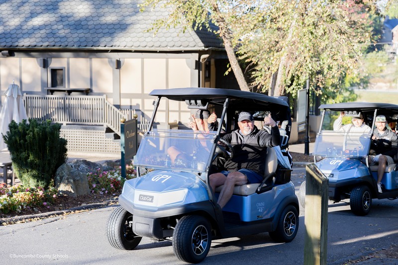two men on golf cart
