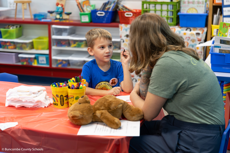 Little boy and mom working on a worksheet.