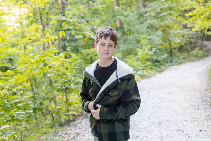 A student smiles while posing on the trail.