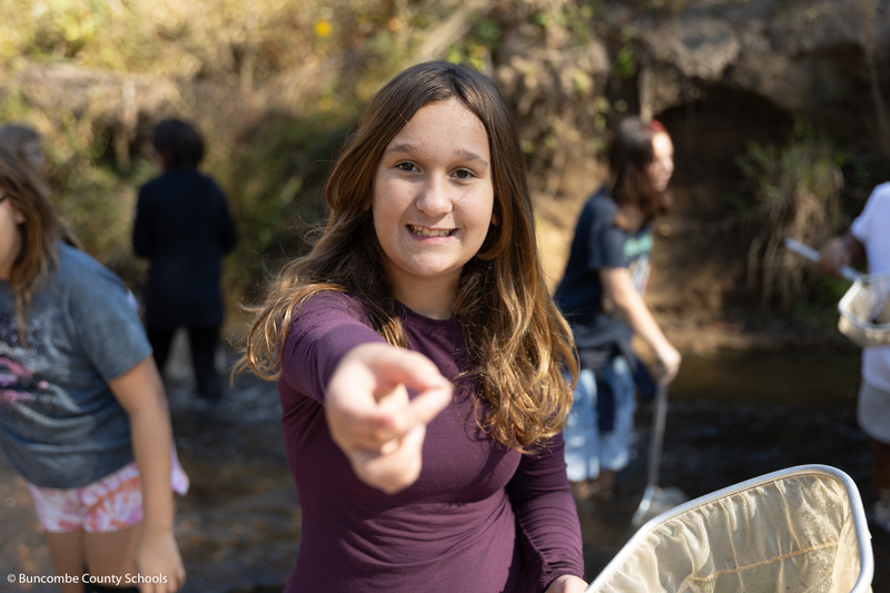 Student holding up an organism.