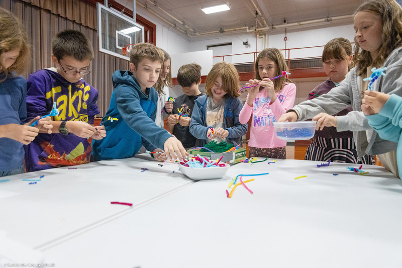 A group of students participate in a neuron project.
