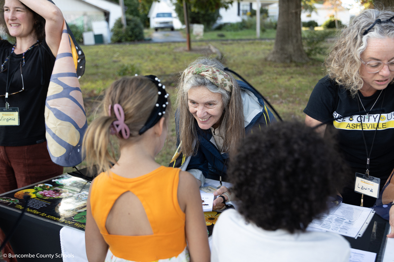 Member of Bee City USA talking to a student.