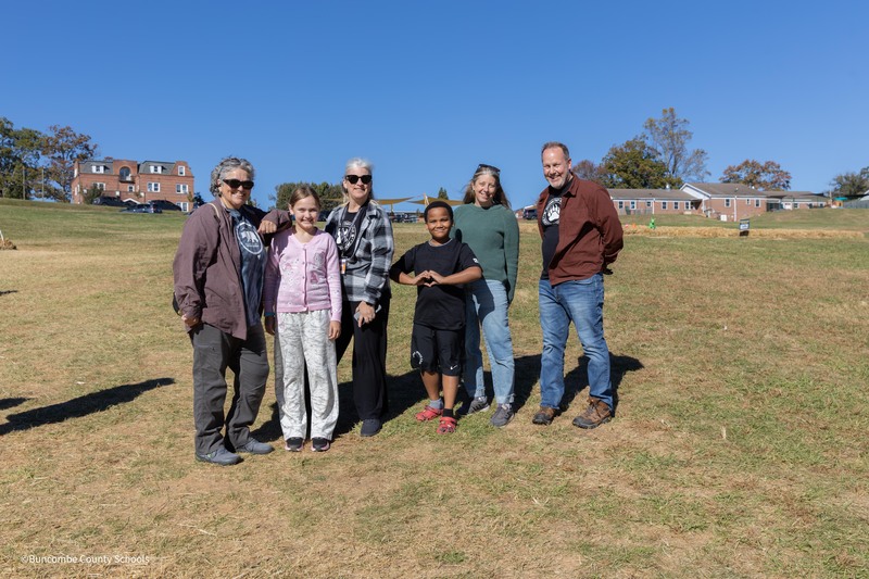 students and teachers pose  for a picture