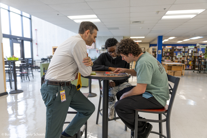 Principal Alexander working with students.