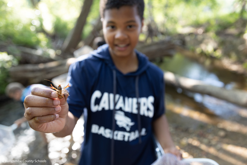 Boy holding a crawfish
