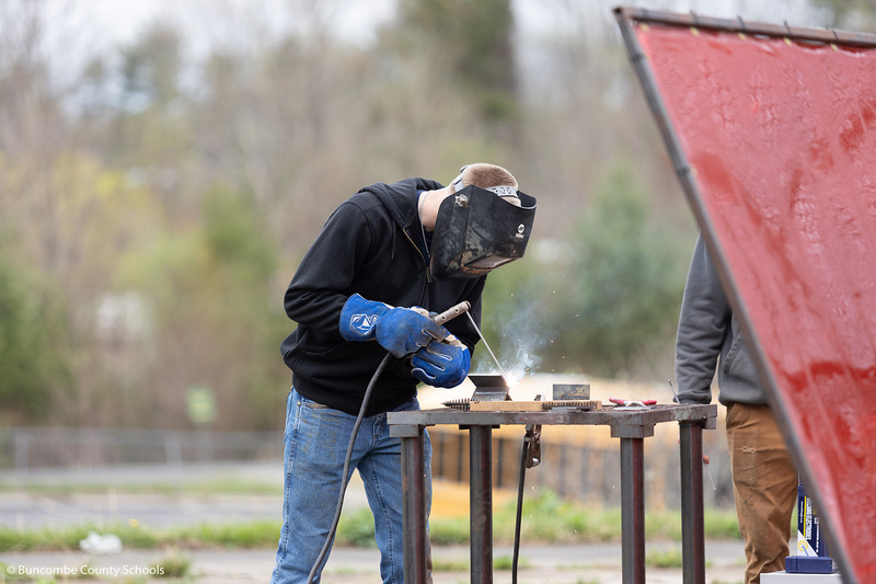High school student showing off wielding skills. 