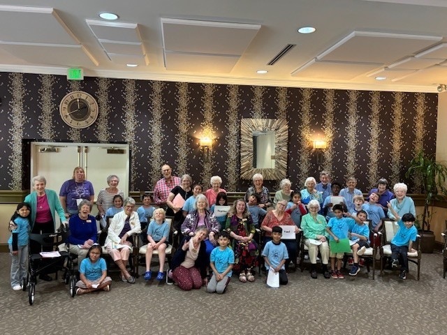 Group of students with the Ardenwoods resident taking a group photo. 