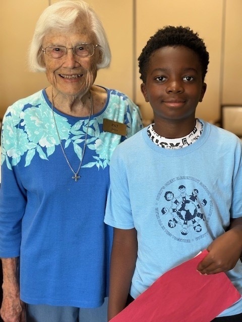 Student posing with a resident of Ardenwoods for a photo. 