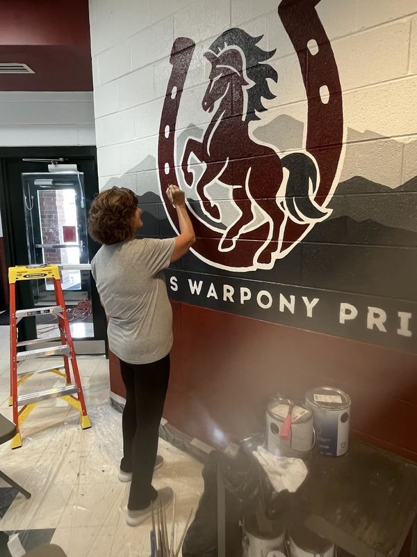 Mrs. Mary Brown helping paint the mural