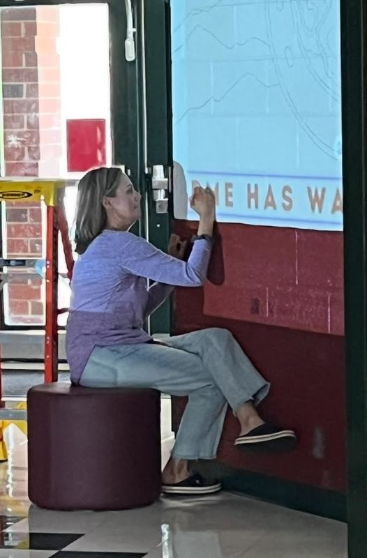 Mrs. Jolie Adtkins tracing the mural. 