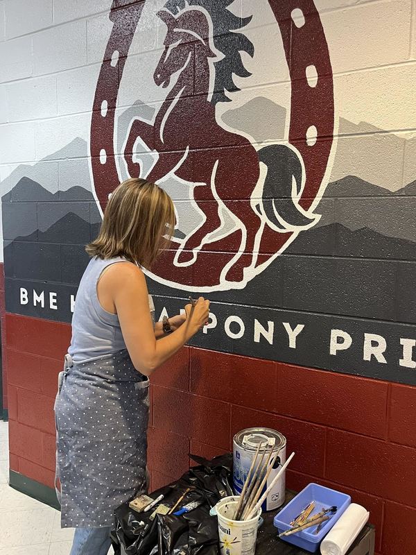 Mrs. Adtkins putting the final touches on the mural. 