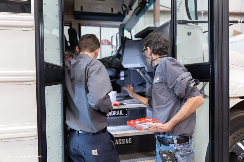 bus mechanics working on bus