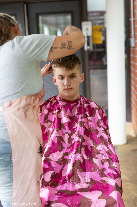 Male student getting his haircut. 