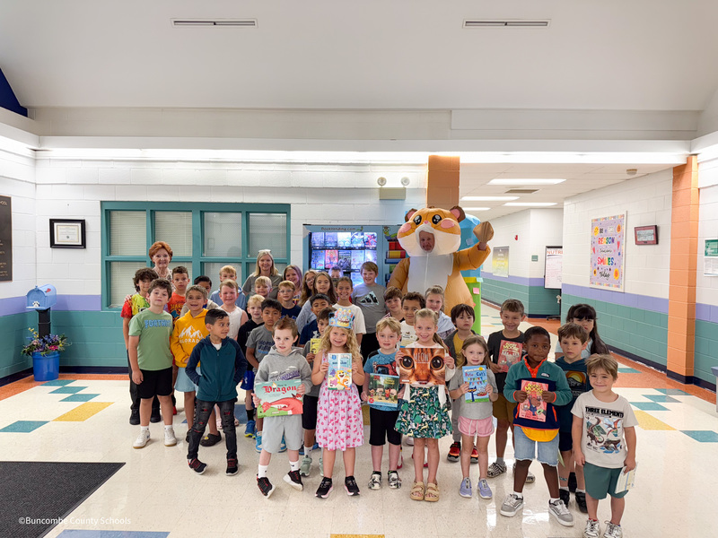 students with august birthdays with enka board rep judy lewis infront of the vending machine