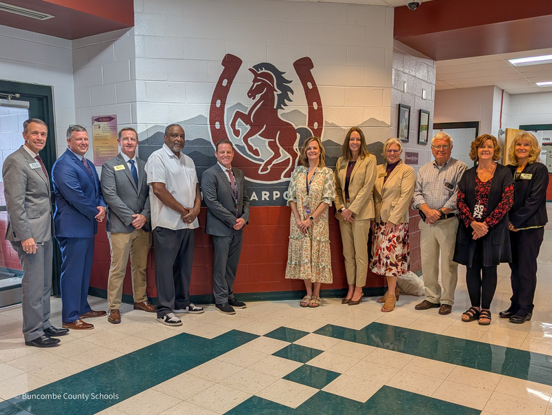 Dr. Jackson, Mr. Cody, Mr. Cheatham, Mr. Pertiller, Mr. Honey, Mrs. Atkins, Dr. Johnson, Dr. Reed, Mr. Sobol,  and Mrs. Thorpe stand in front of the new mural