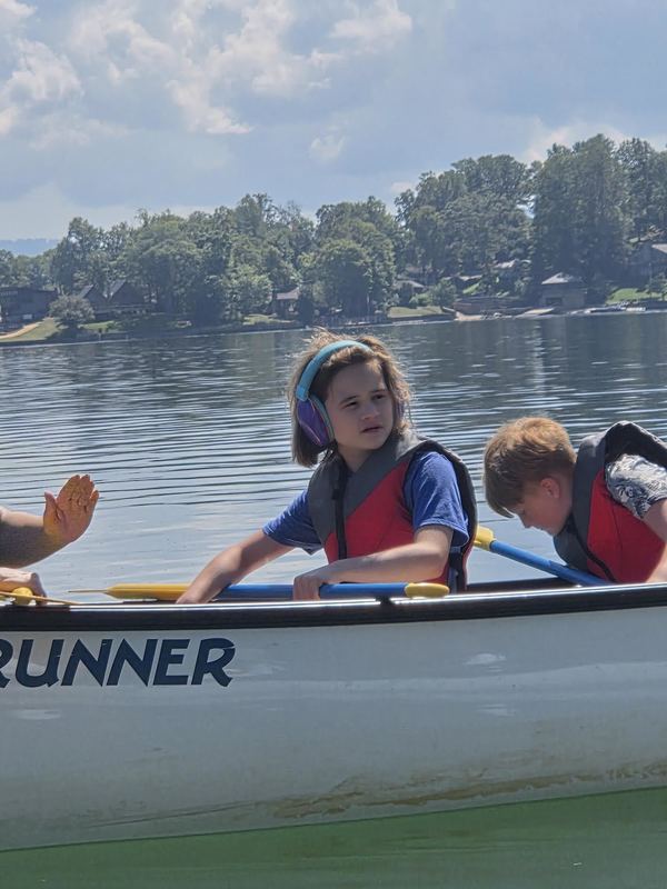 Student riding in a canoe looking at their surroundings. 