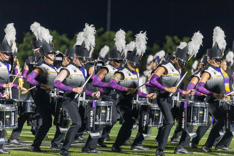 The drum line in full uniform from Western Carolina University playing on the field.