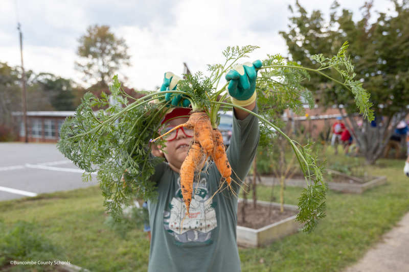 student holding carrot