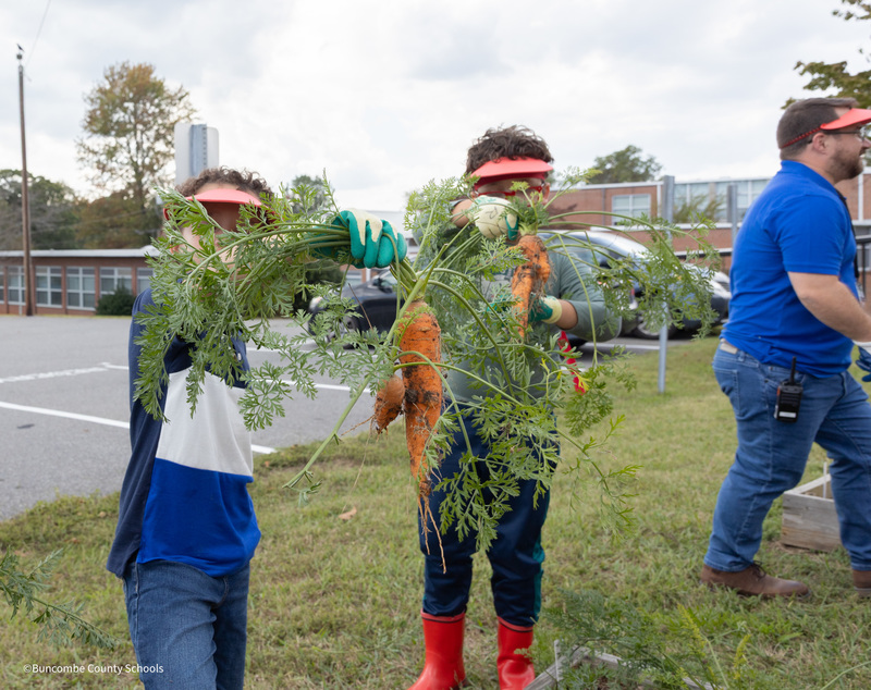 students showing their harvest bounty