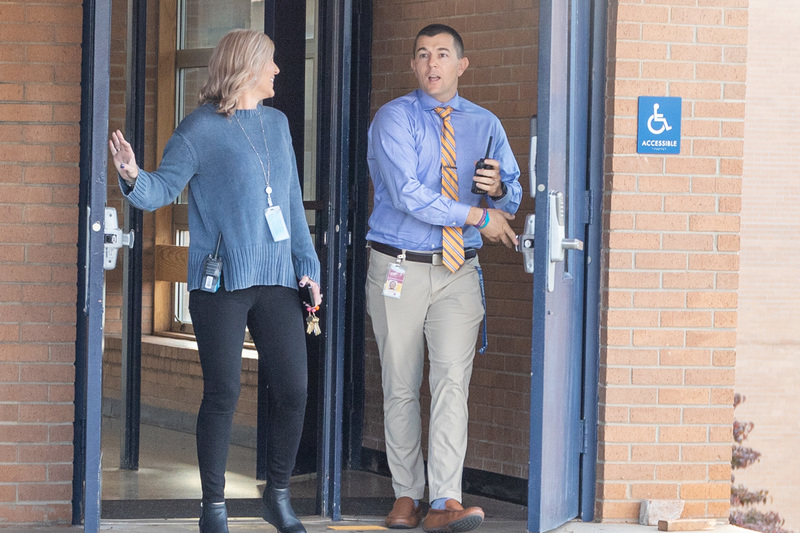 Ms. Harris and a surprised Mr. Harbin walk out the doors at Enka High School