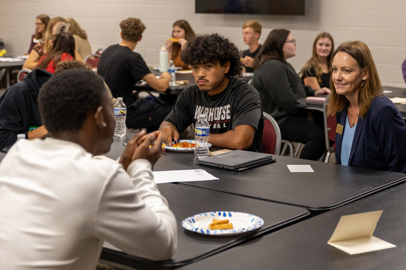 Dr. Johnson sites with students