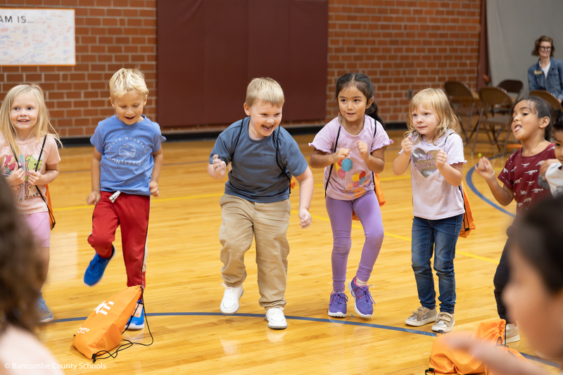 Group of Kindergarten students running in place in their new shoes. 