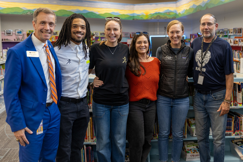 BCS Superintendent Dr. Rob Jackson and Estes principal Jay Dale stand on the end of row of people with volunteers from the Christos Foundation and the PTA in between them.