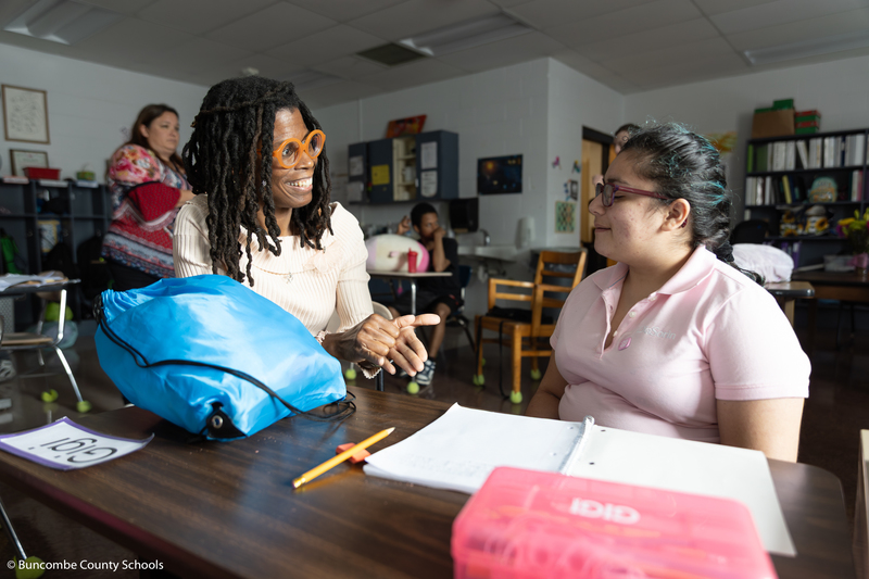 Dr. Wilson talking to a female student. 