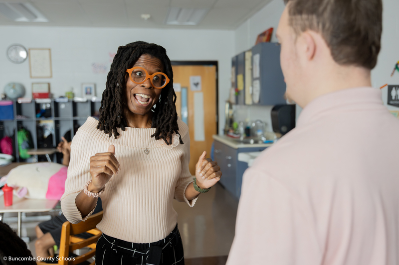 Dr. Wilson talking to a male student. 