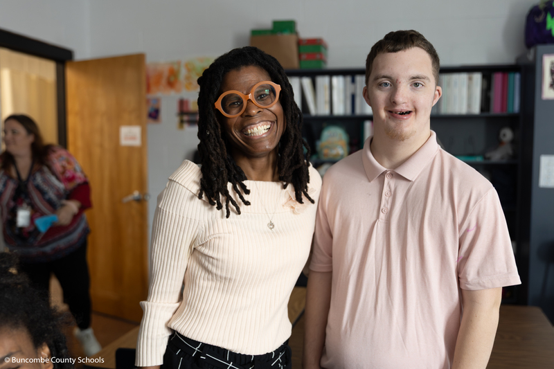Dr. Wilson posing for a photo with a  student. 
