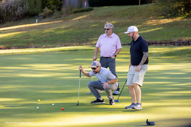 three men playing golf