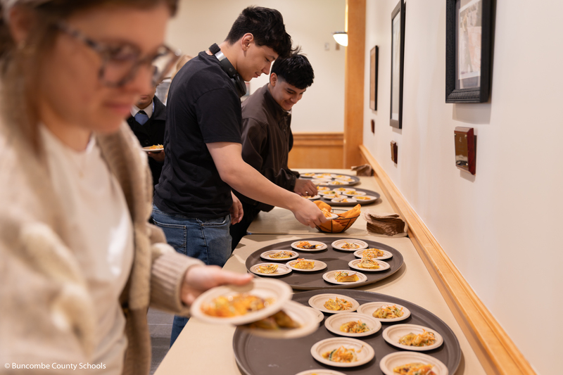 Students picking up samples of food made by the culinary department.