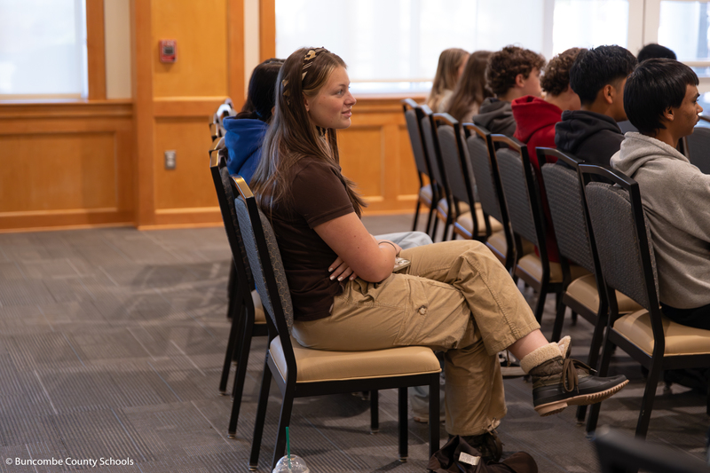 Student listening intently to the college students talk about their program.