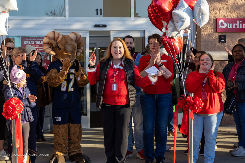 Burlington manager Tina speaks to a cheering crowd in front of the store during its grand opening celebration