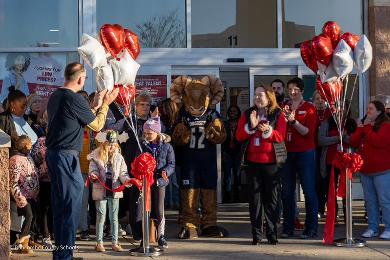The crowd in front of Burlington applauds after the grand opening ribbon is cut.
