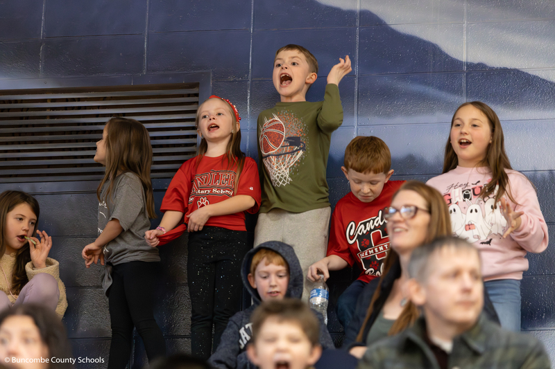 Group of kids cheering loudly.