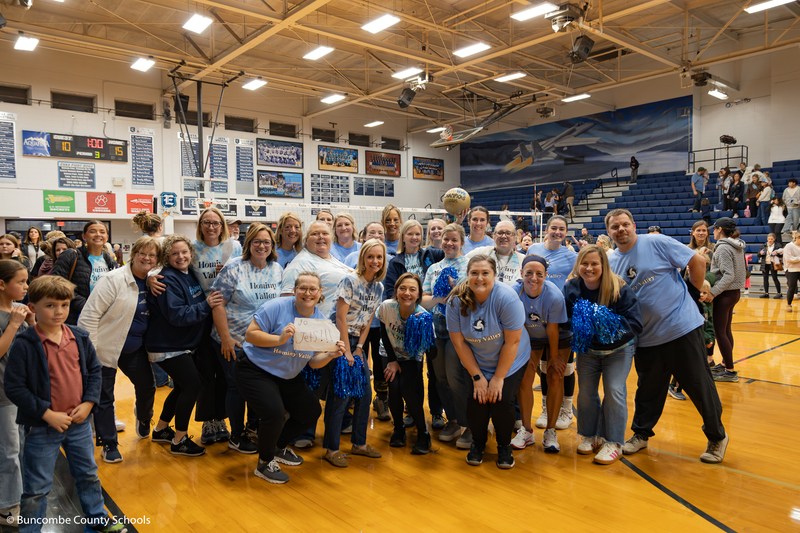 Hominy Valley staff posing for a group photo with the coveted golden volleyball after their triumphant win against Candler Elementary.