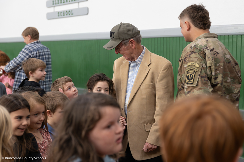 Student giving a veteran a hug. 